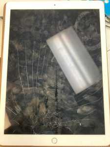 Broken Apple iPad glass and damaged LCD screen requiring professional repair